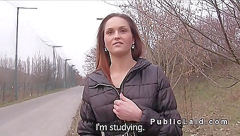 Cute redhead gets out of a vehicle and plays with her lips