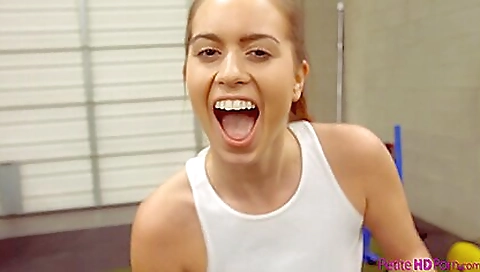 Busty brunette in pink shirt and leggings in the gym