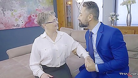 A sexy blond granny with a nice figure is dressed up in stockings